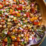 mango chickpea salad in a serving bowl with a spoon