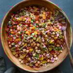 mango chickpea salad in a serving bowl with a spoon