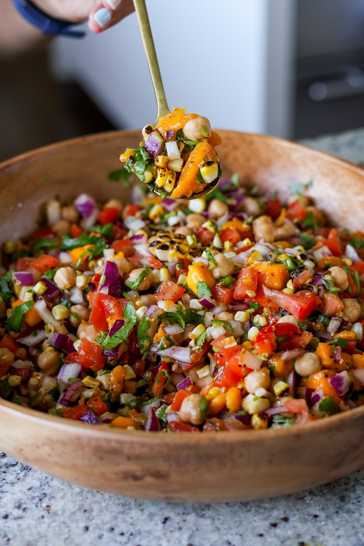 spoon serving up mango chickpea salad