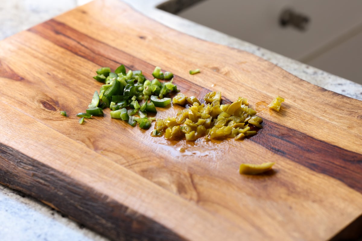 chopped fresh and pickled jalapeños on the cutting board
