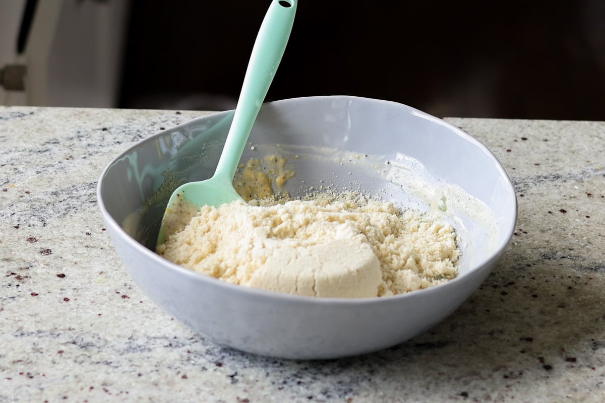 adding almond flour to the bowl