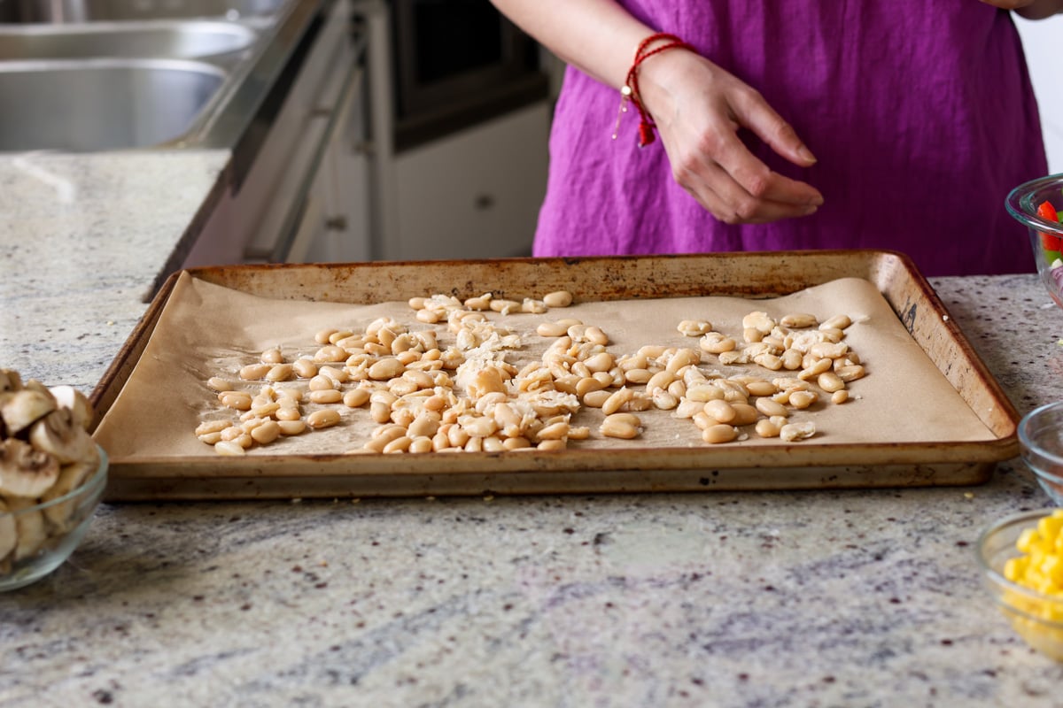 smashing beans on the sheet pan
