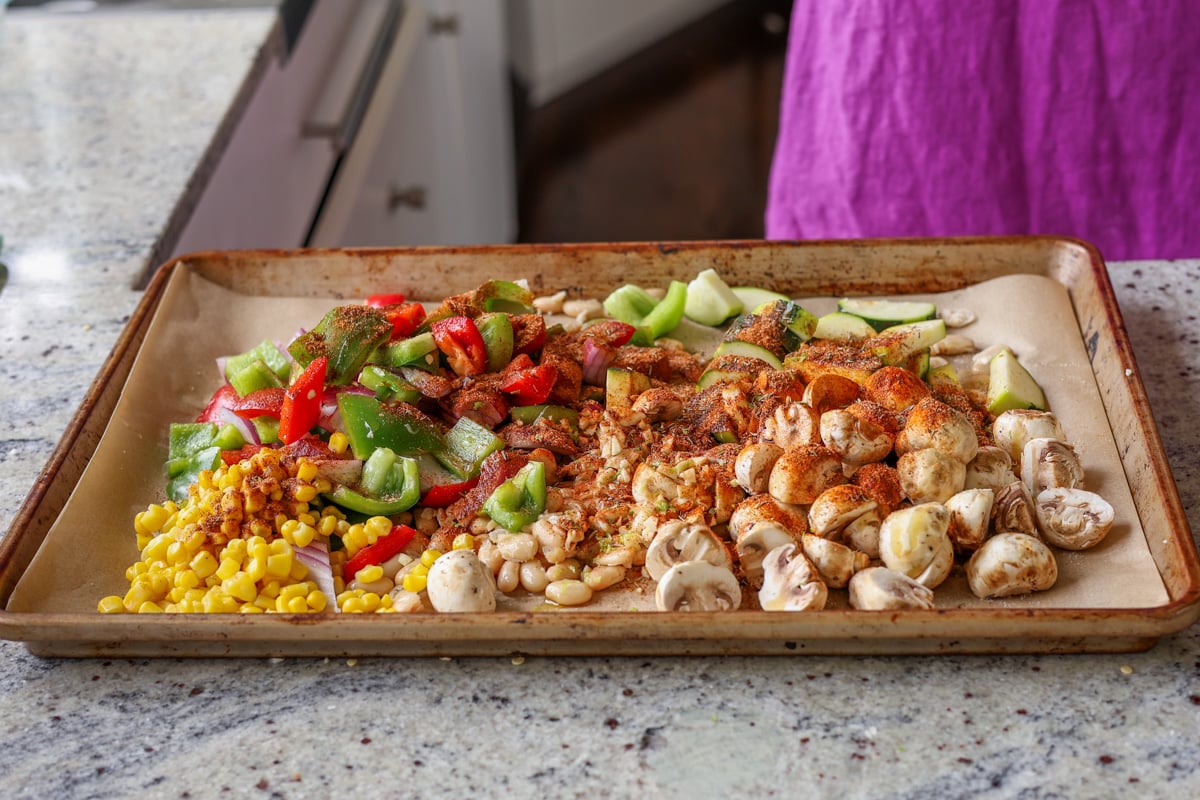 adding spices to the beans and veggies