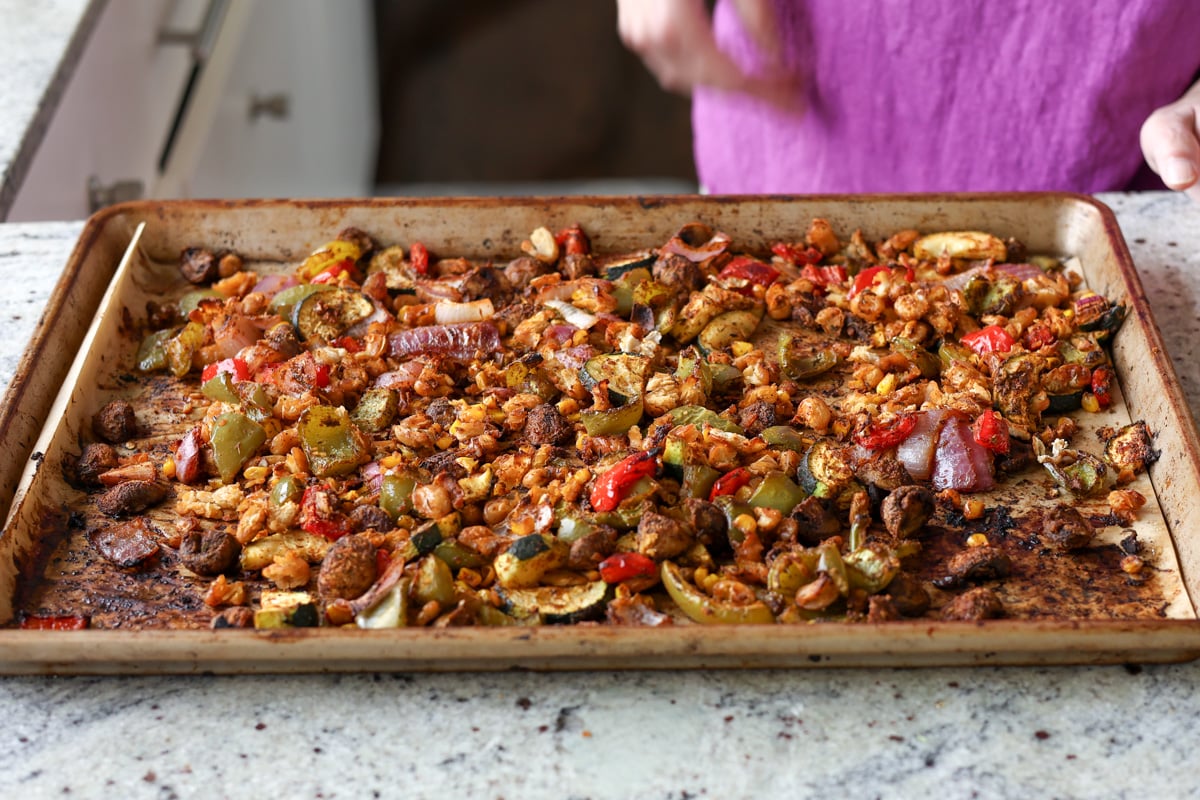 cajun beans and veggies on the sheet pan after baking