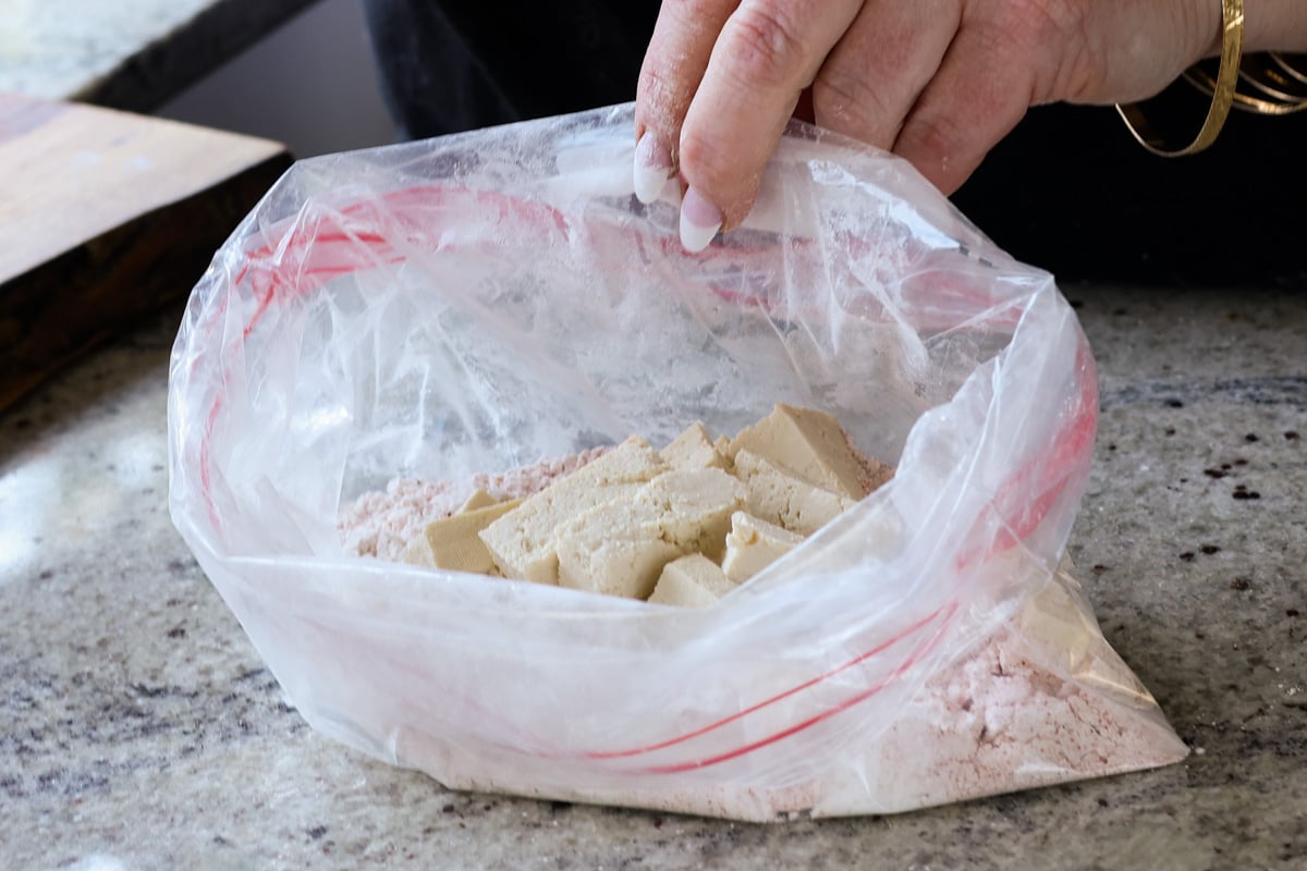 adding tofu to the zip top bag