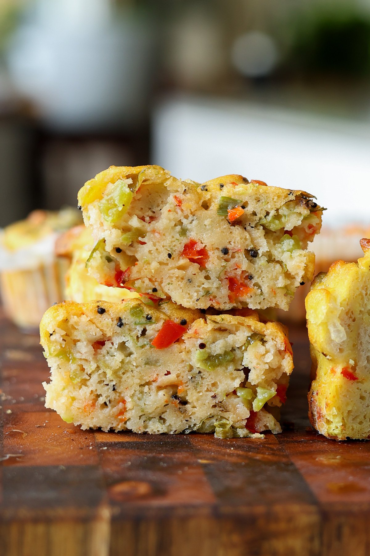 close-up of moong egg muffins on the cutting board with one cut in half, so you can see the inside