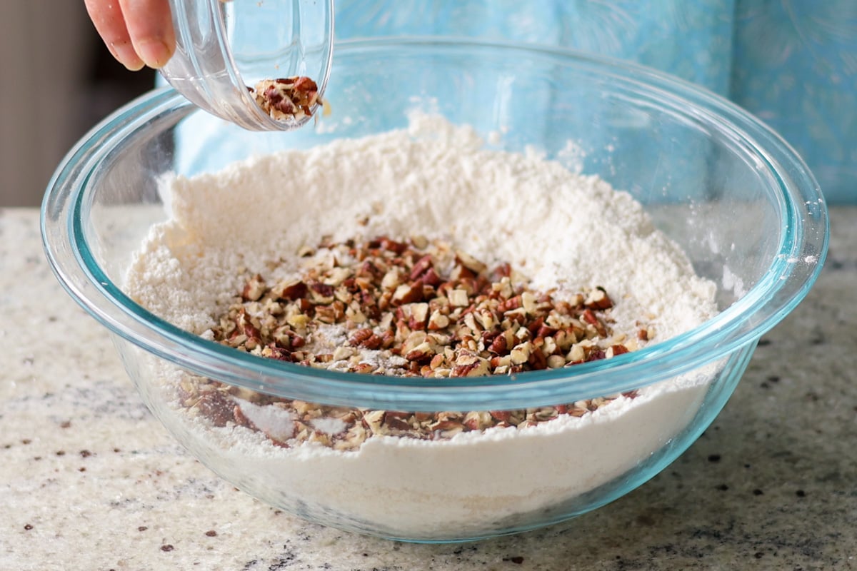 adding pecans to the dry ingredients