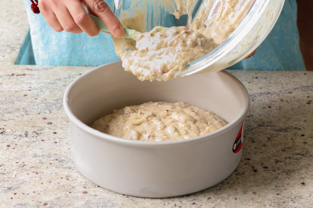 spooning the Italian cream cake batter into the pan
