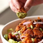 piece of tofu 555 dipped in cilantro mint chutney