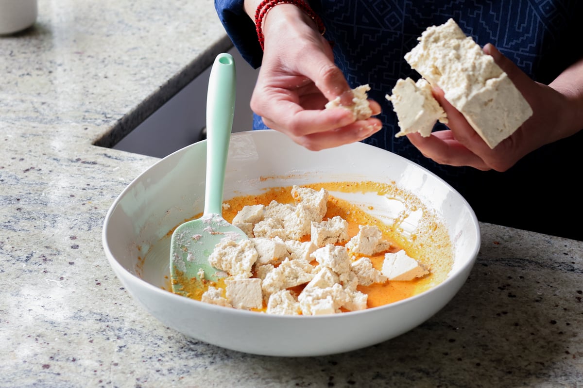 adding tofu pieces to the vegan chicken 555 batter