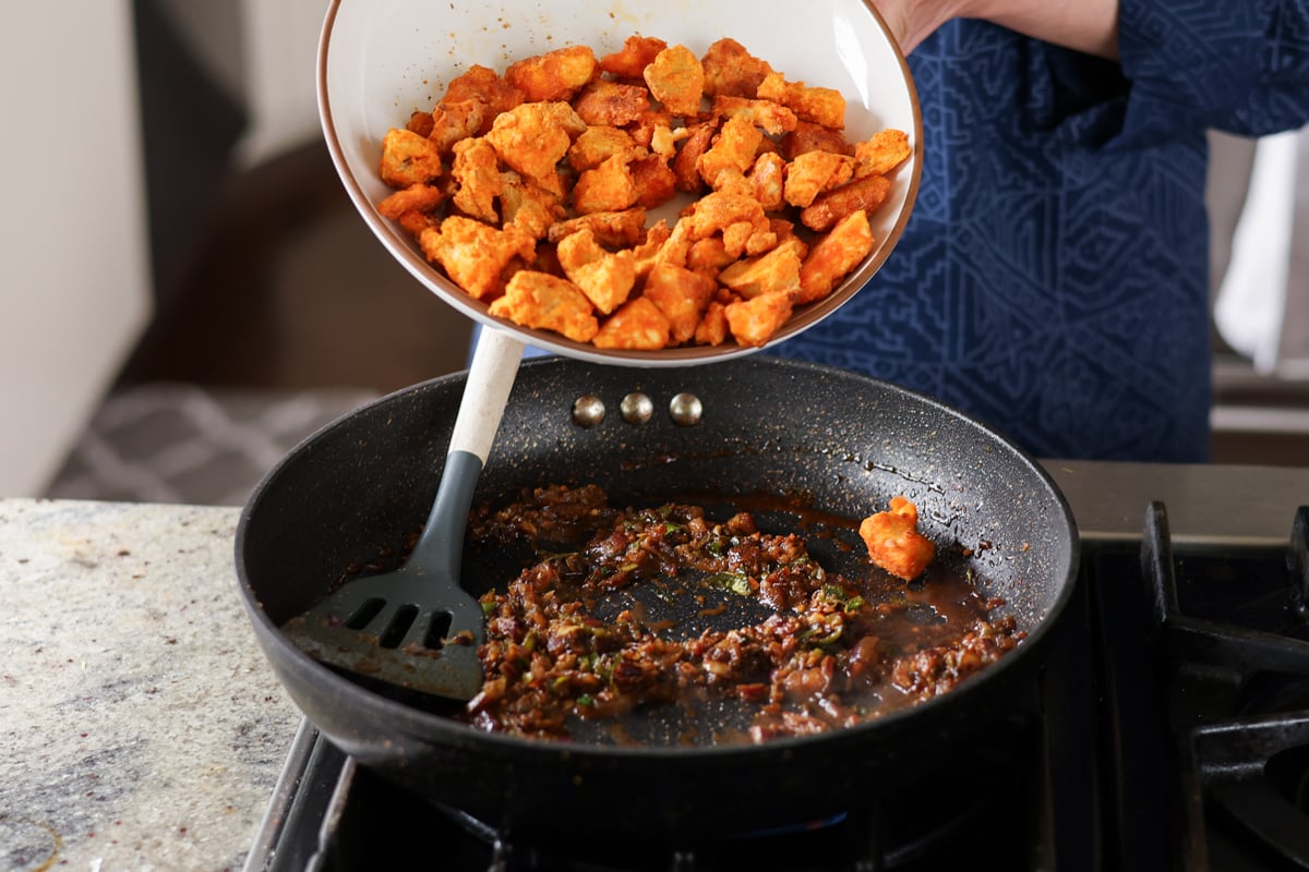 adding crispy tofu to the chicken 555 sauce