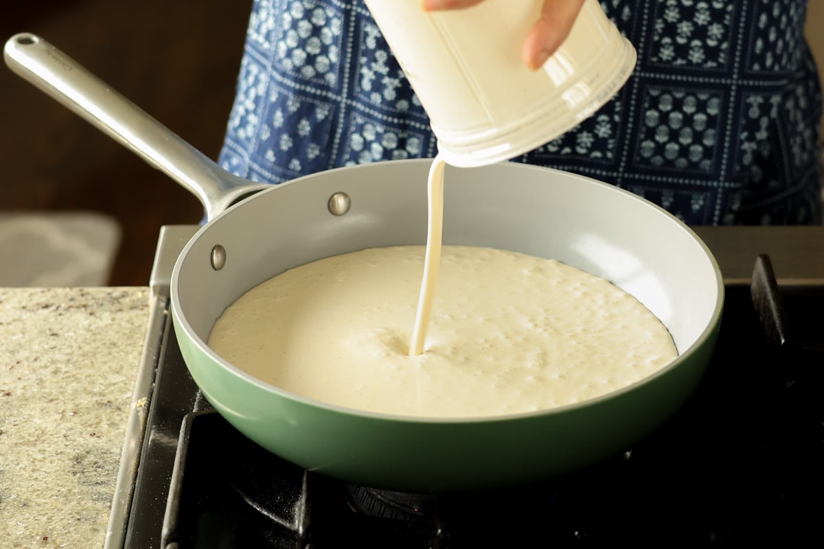 adding cardamom cream to the pan