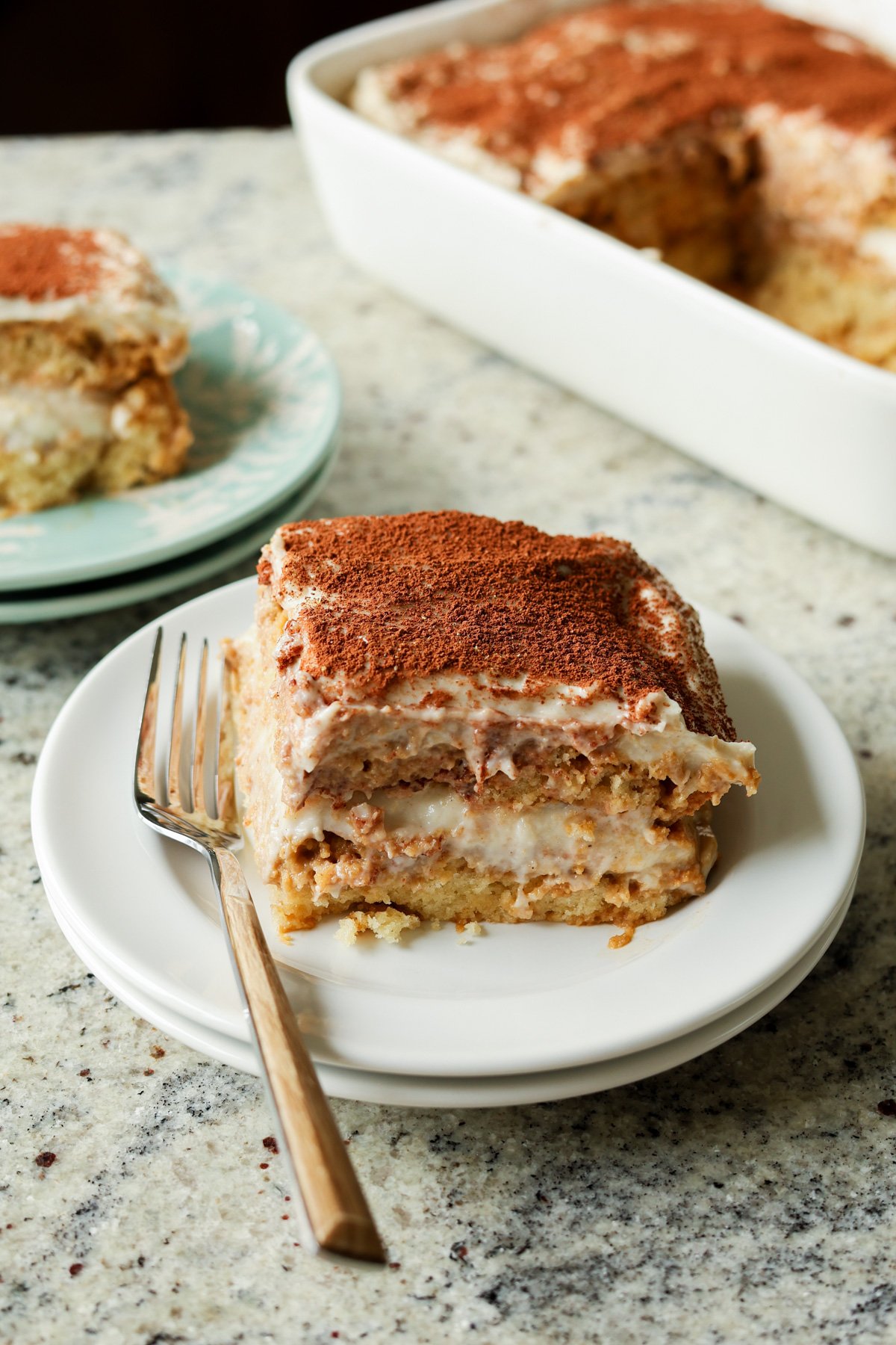 slice of chai tiramisu cake on a plate with a fork