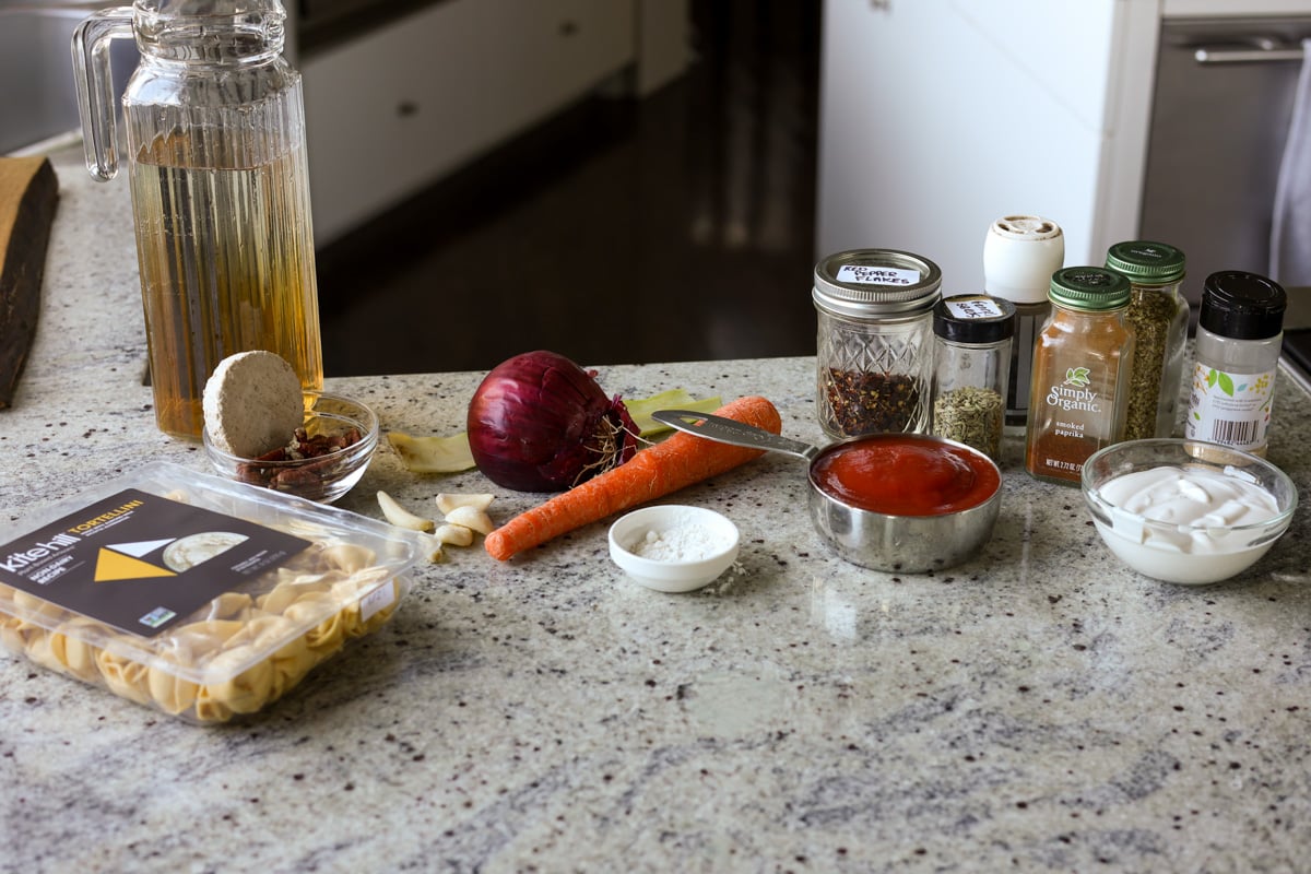 tortellini soup ingredients on the kitchen counter