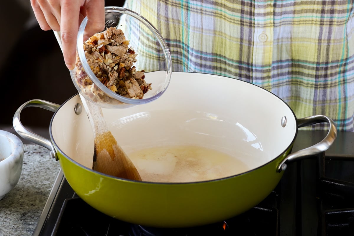 adding sausage mixture to the pan