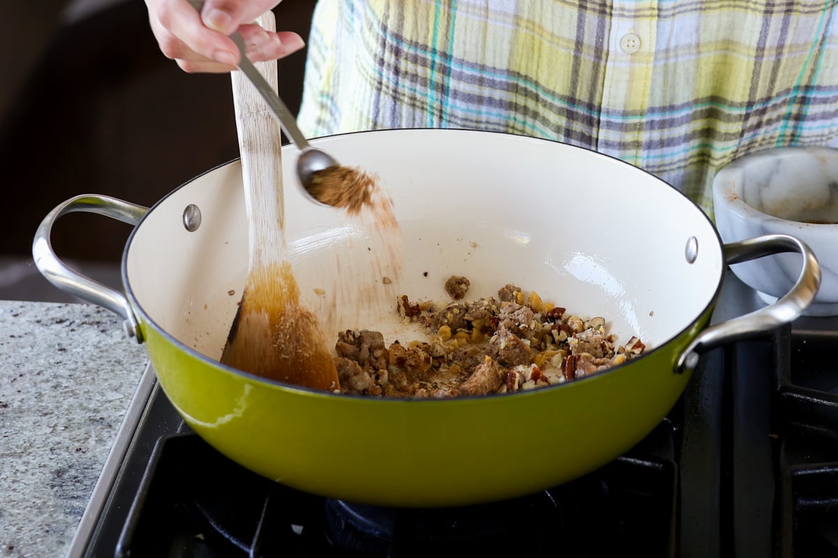 adding sausage spice mix to the pan
