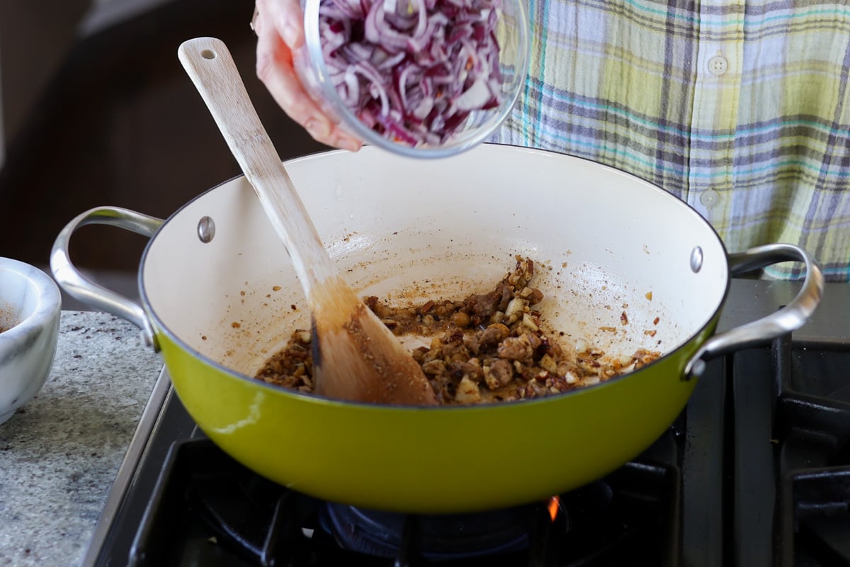 adding onions to the pan