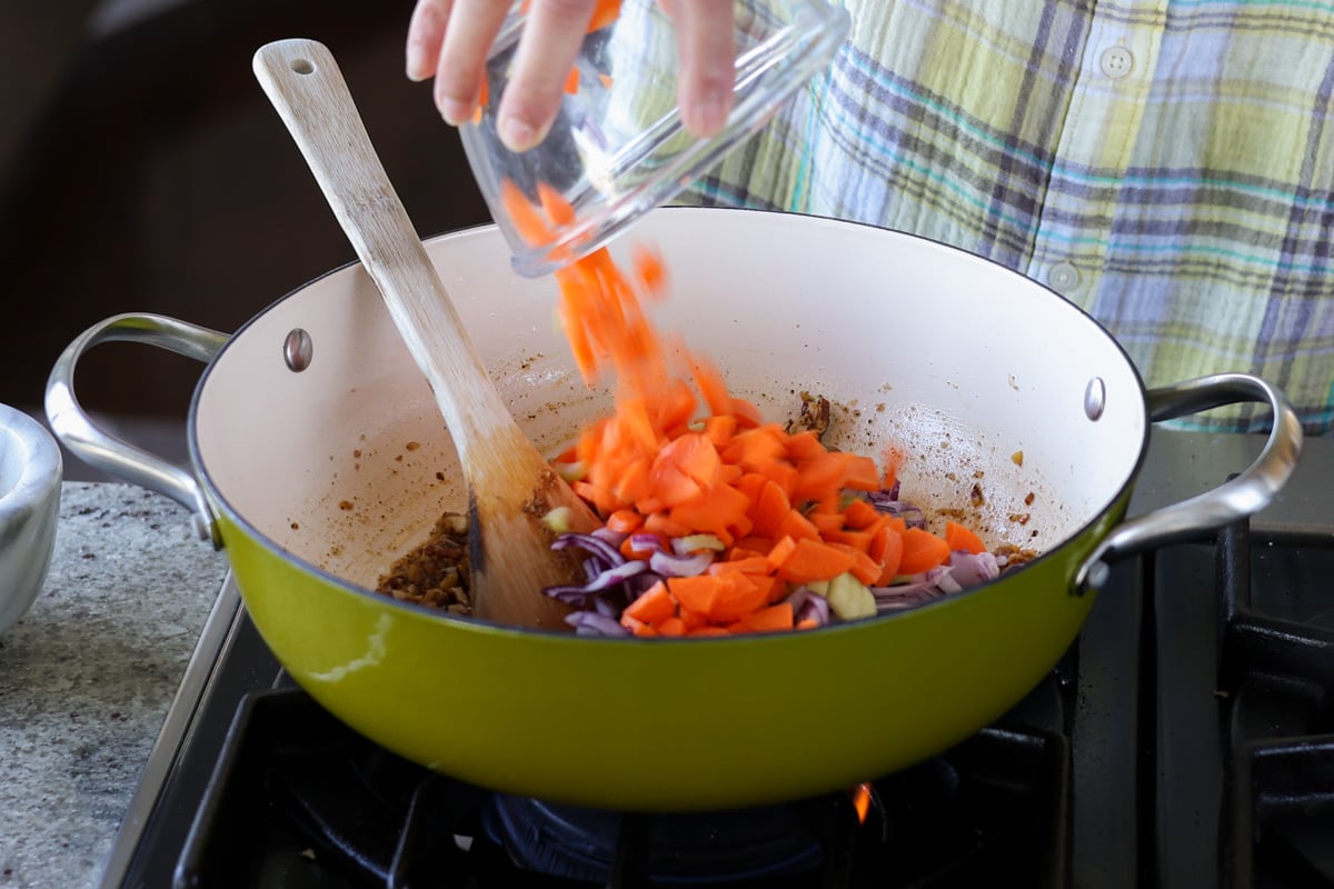 adding carrots to the pan