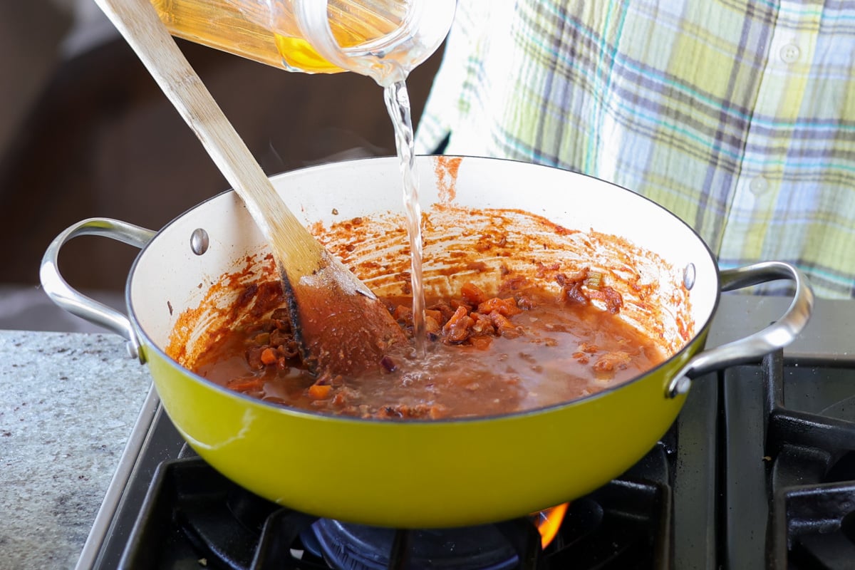 adding stock to the pan