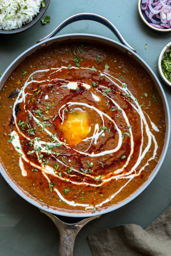 authentic dal makhani in the pan with tadka and toppings
