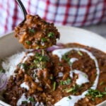 spoon taking a bite of dal makhani