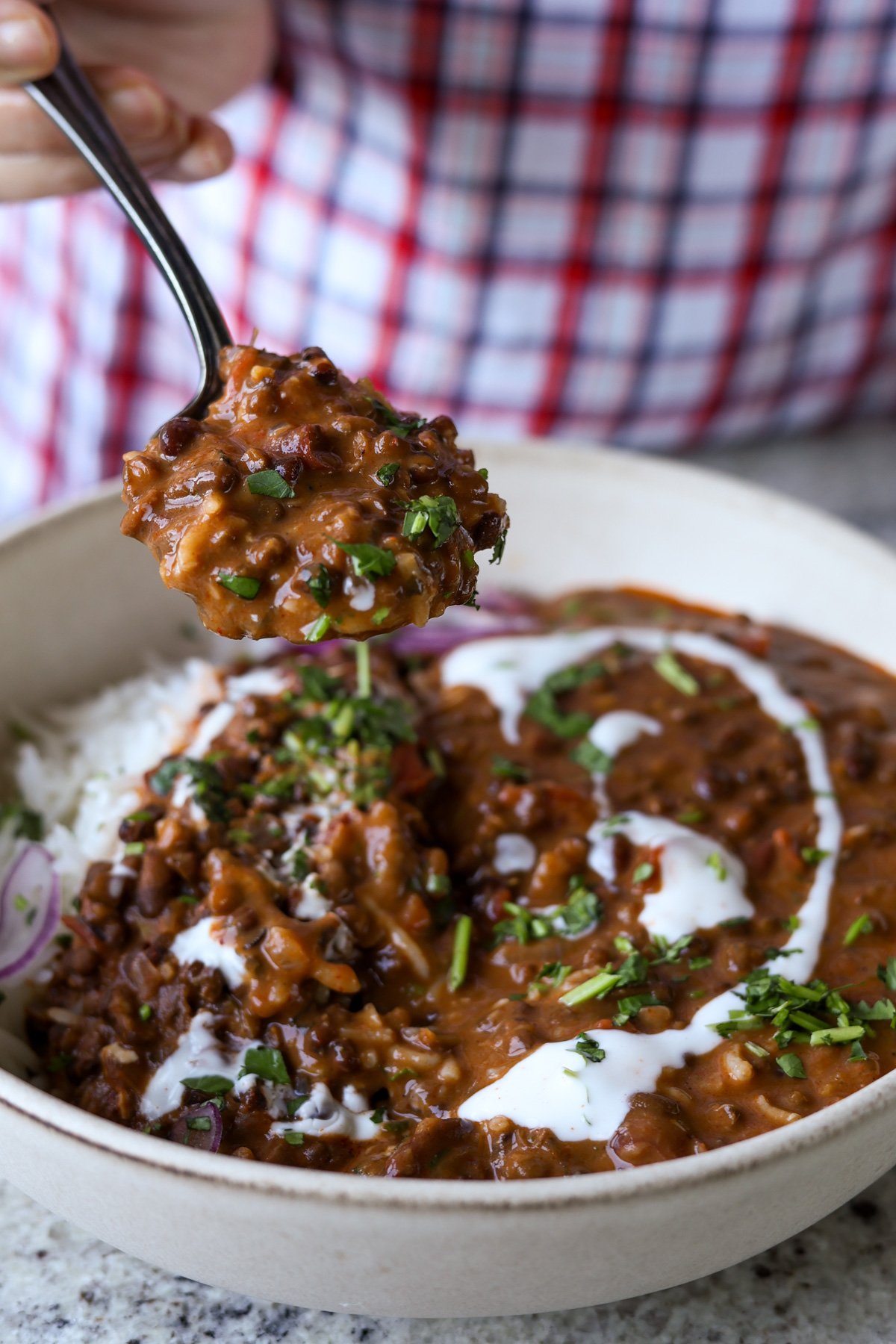 spoon taking a bite of dal makhani