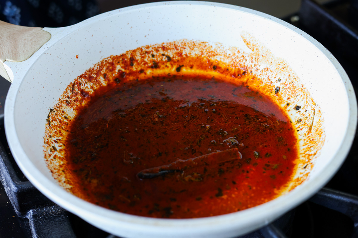 tadka in the pan after adding the burnt cinnamon stick