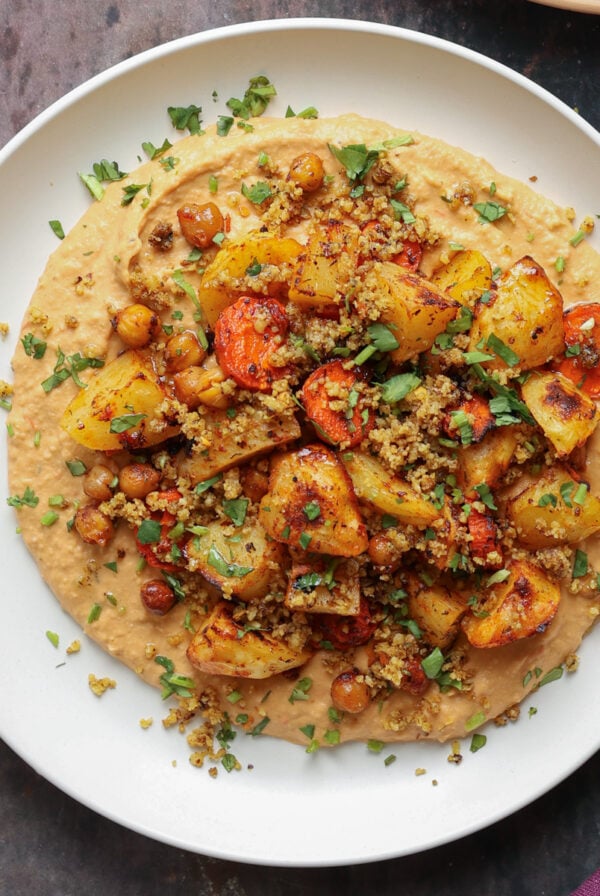 harissa bean puree topped with roasted vegetables and baharat walnuts