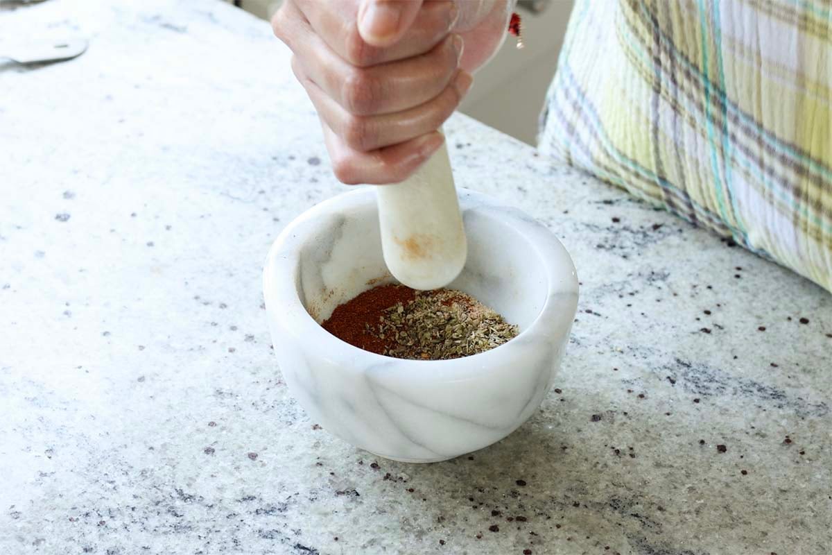 sausage spice mix in the mortar and pestle before grinding