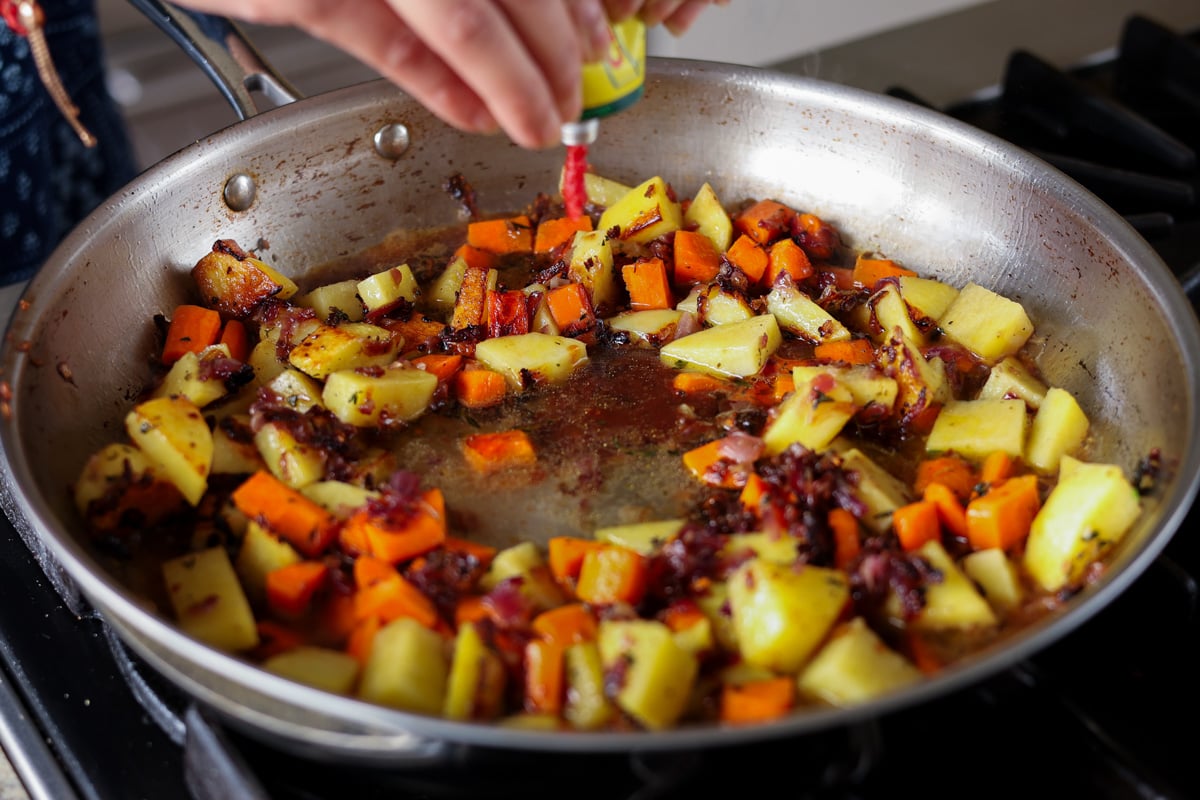 squeezing lime juice into the pan
