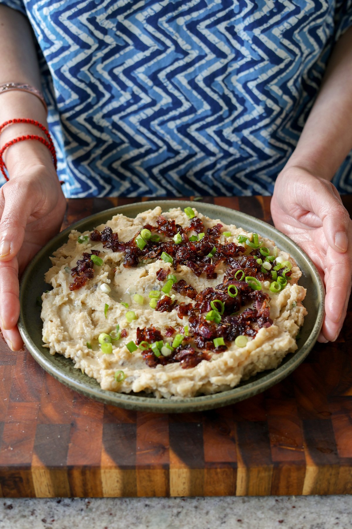 placing a plate of caramelized onion mashed potatoes on the table