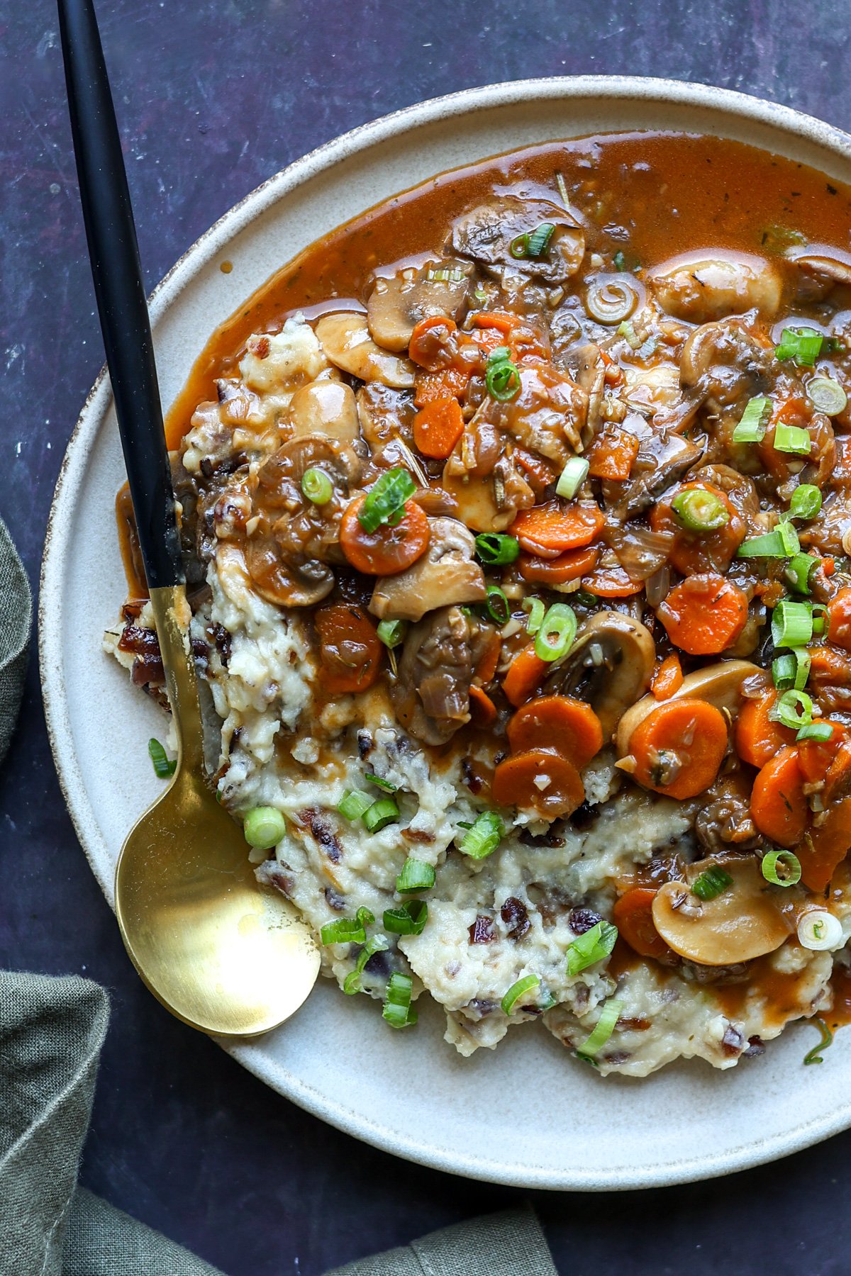 caramelized onion mashed potatoes on the plate topped with gravy