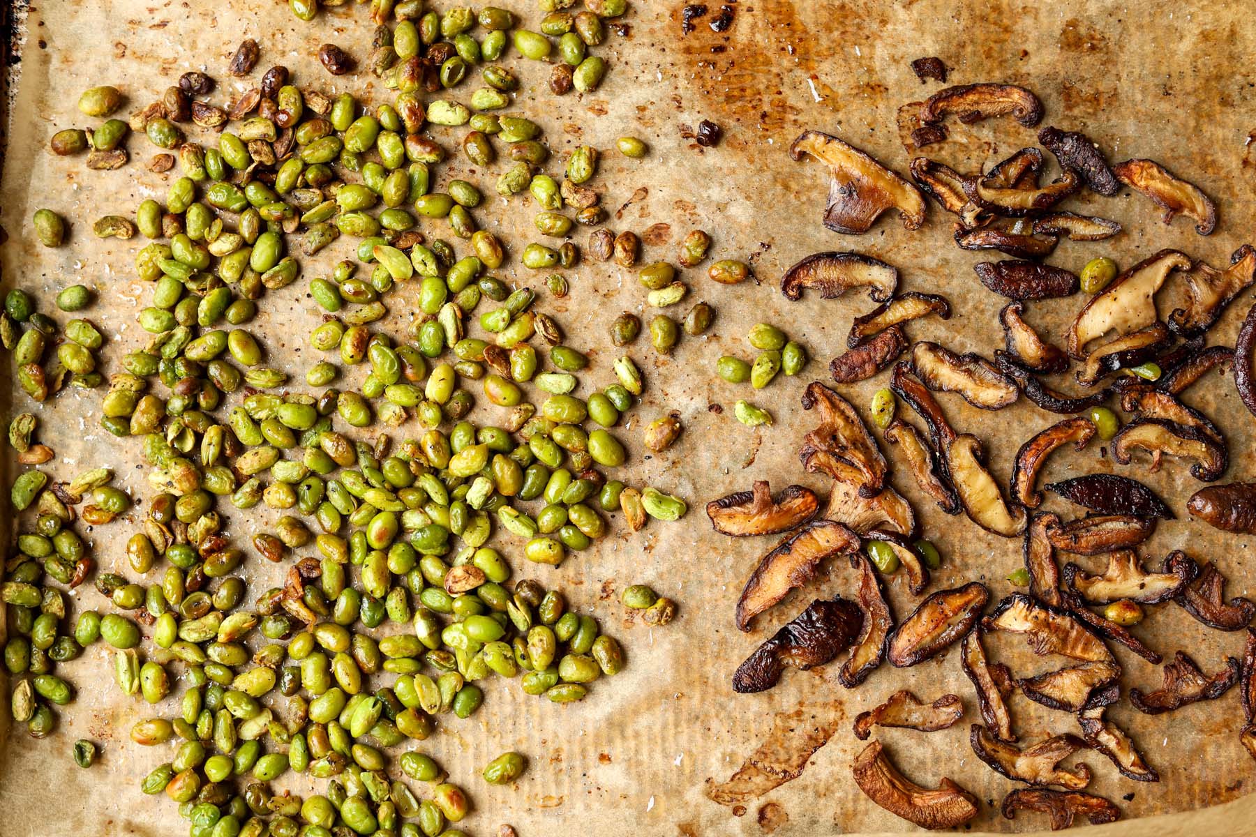 edamame and mushrooms on the pan after baking