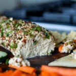 close-up of holiday cheese log after taking out some of the spread