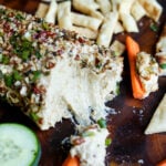 close-up of holiday cheese log after taking out some of the spread