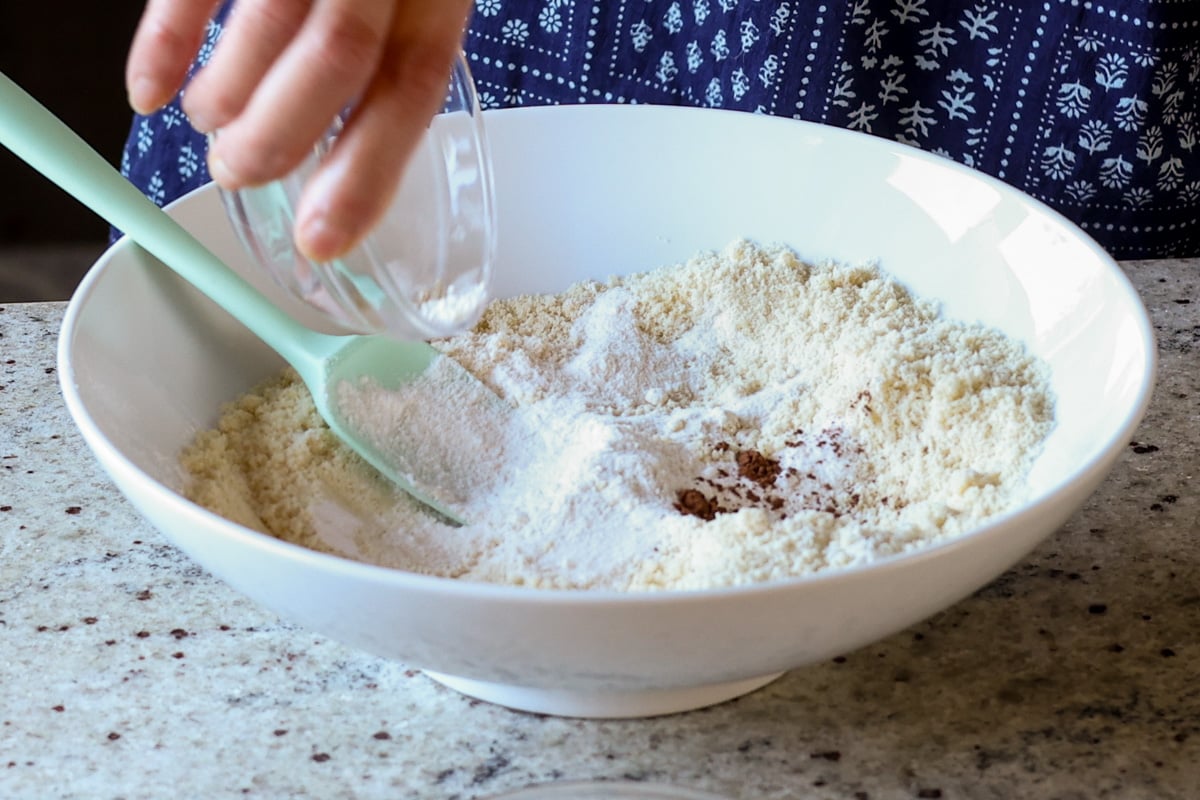 adding dry ingredients to the bowl