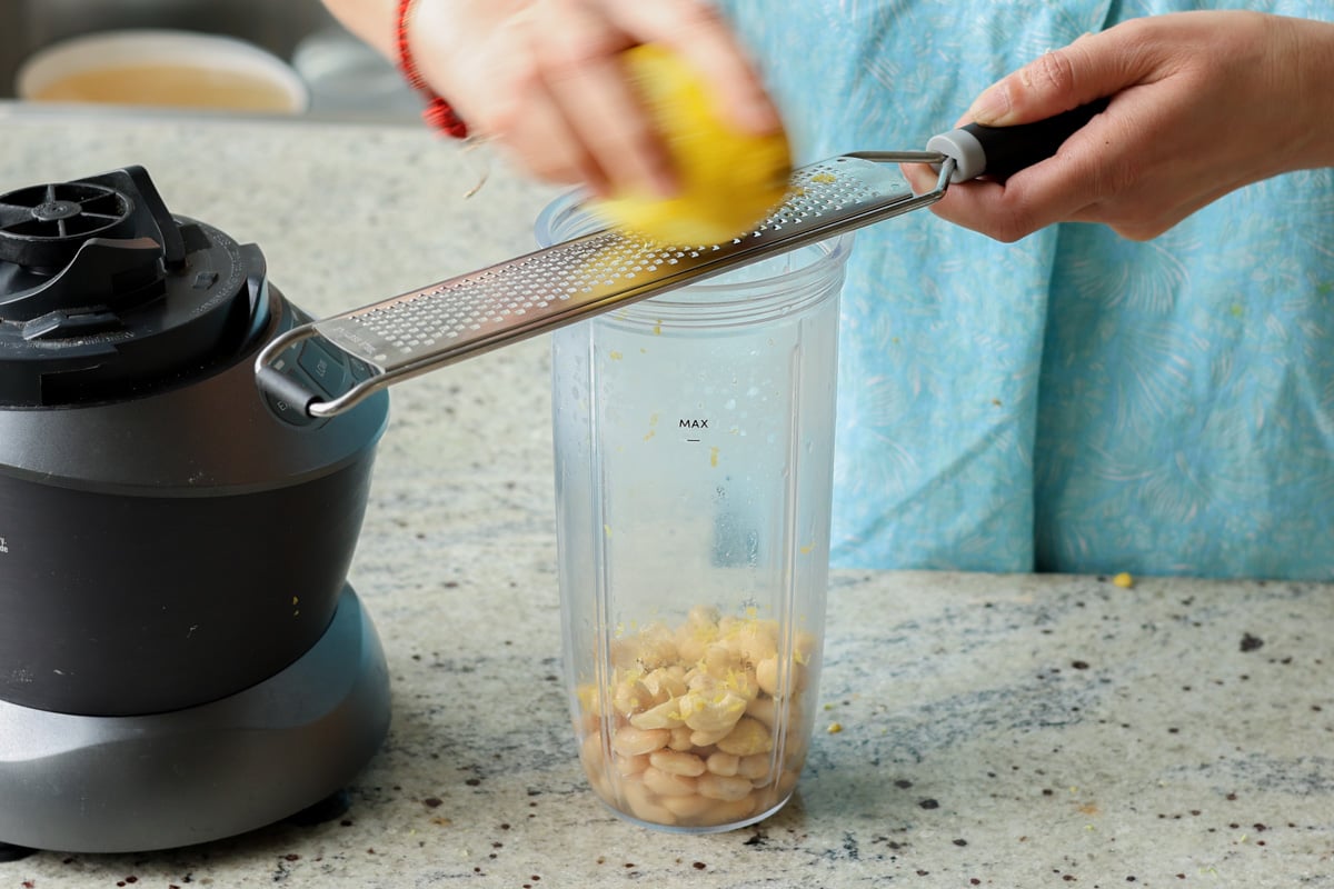 adding lemon zest to the blender