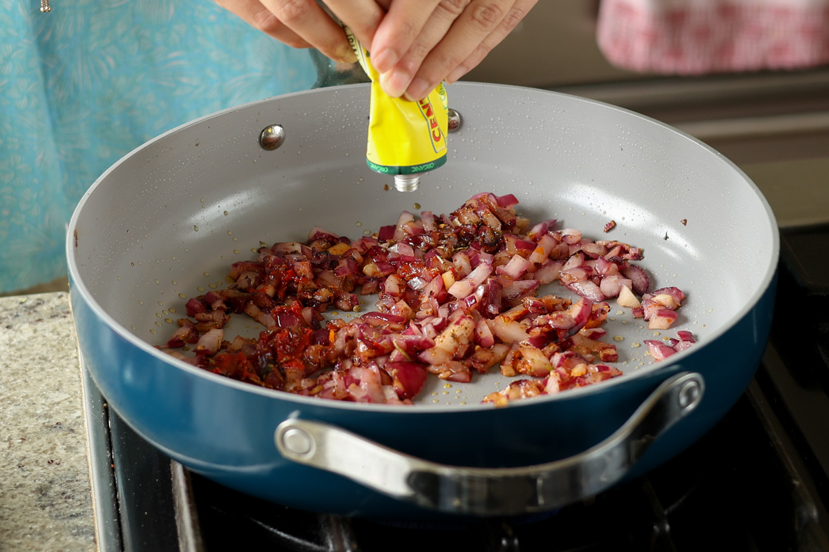 adding tomato paste to the aromatics