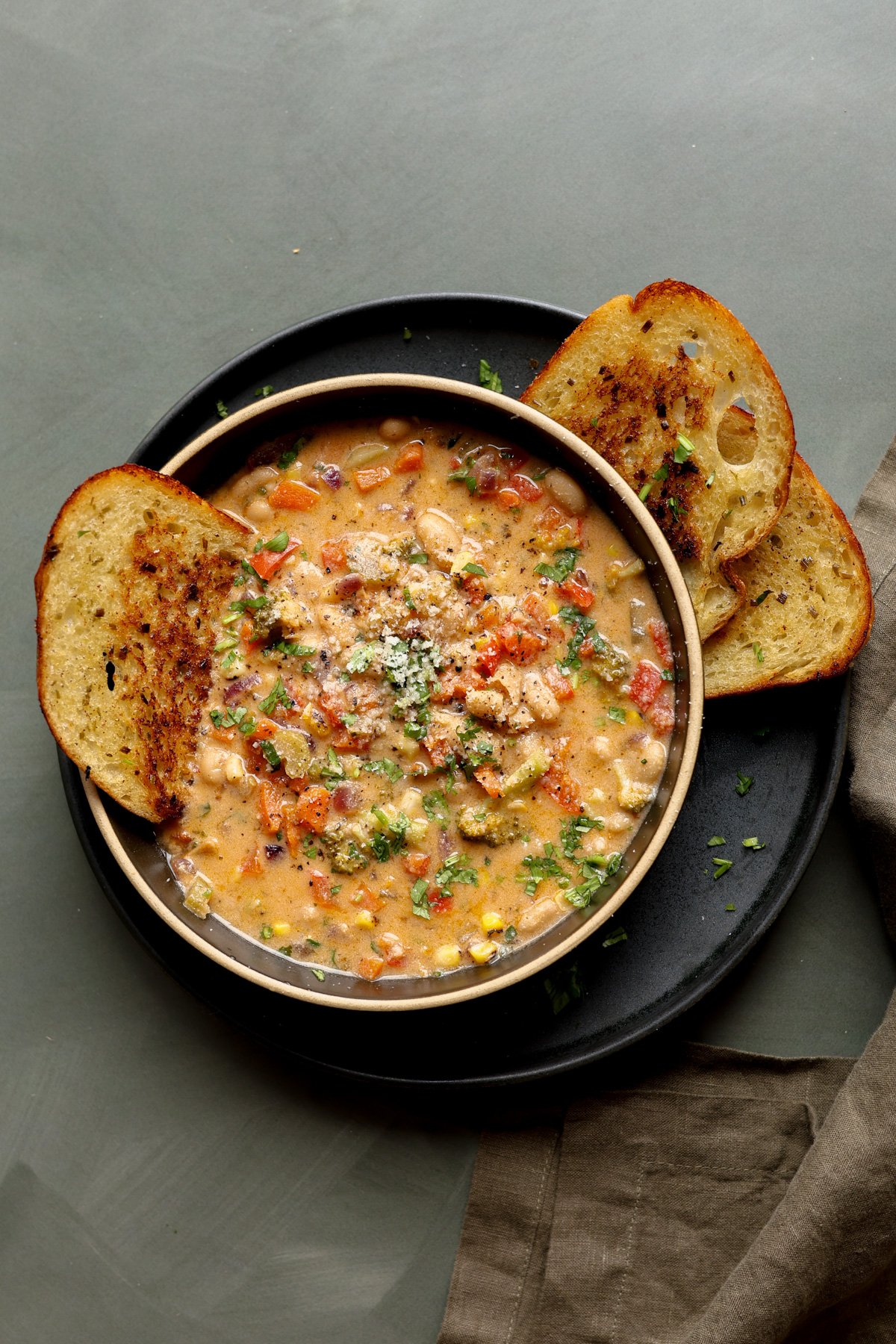 lemon white bean soup in a bowl with garlic bread