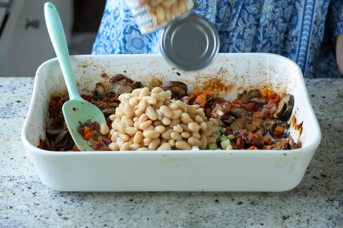 adding beans to the baking pan