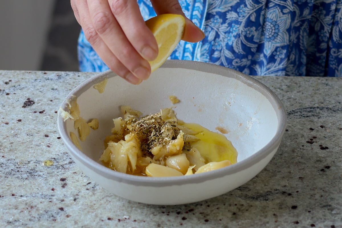 adding garlic butter ingredients to the bowl
