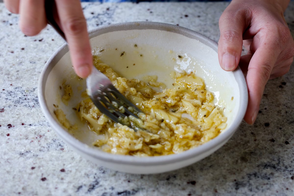 mashing the roasted garlic butter