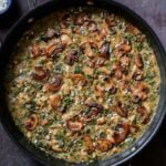 spinach mushroom beans in the pan with garnish