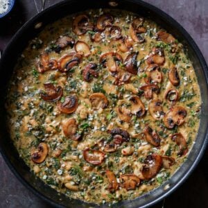 spinach mushroom beans in the pan with garnish
