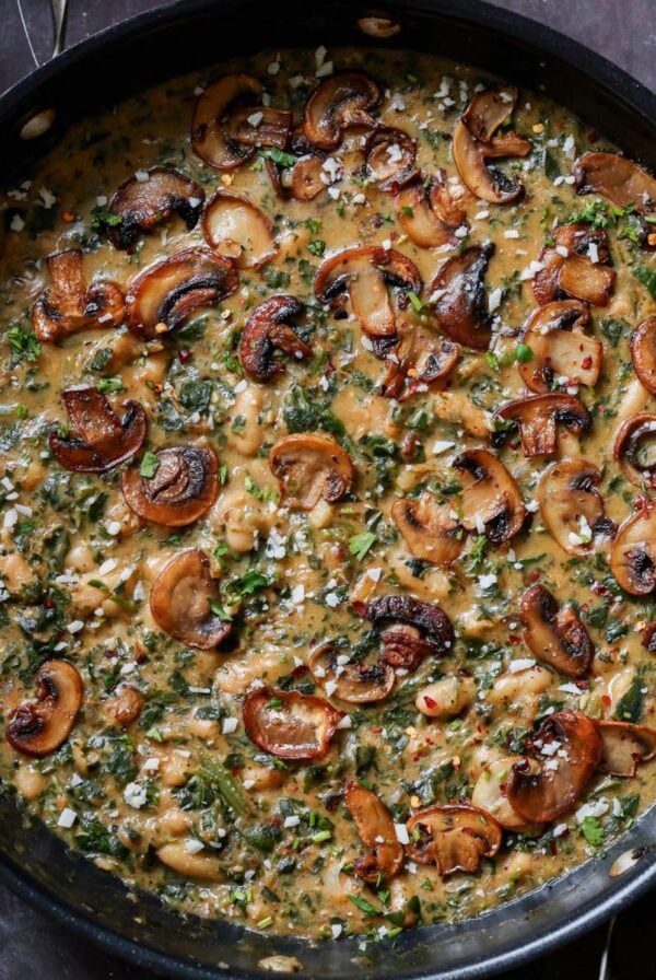 spinach mushroom beans in the pan with garnish