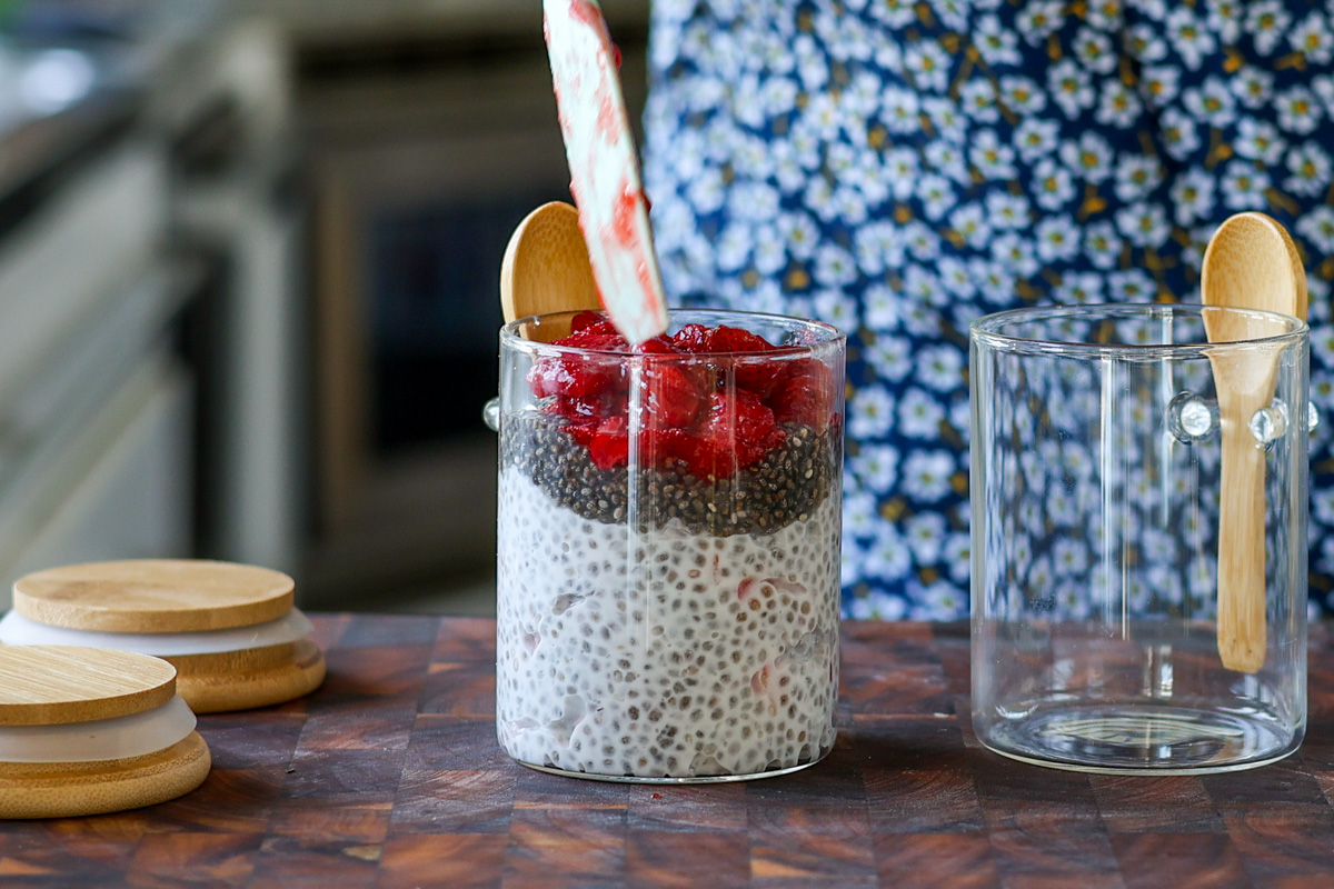 layering the strawberry chia seed pudding in a jar