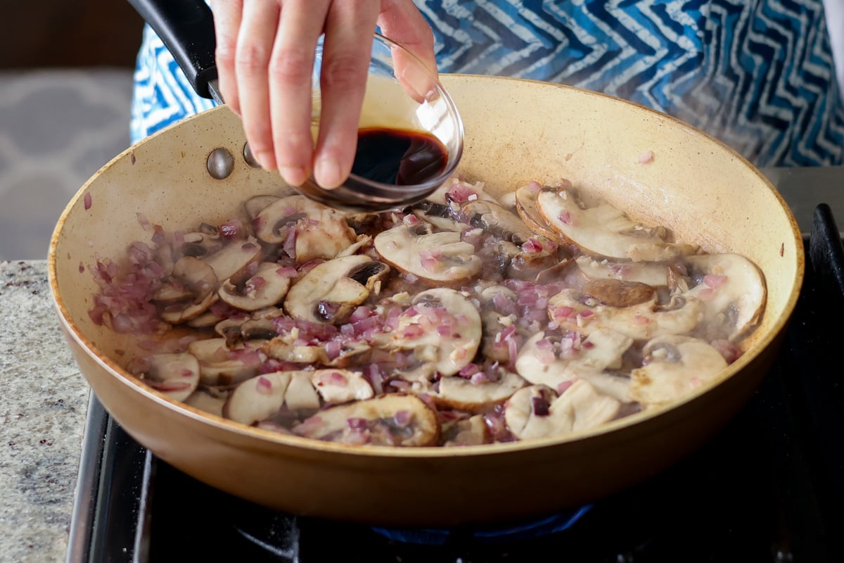 adding soy sauce to the pan