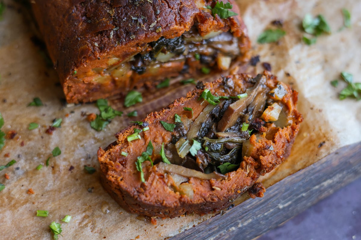 sliced sun dried tomato roast on a cutting board