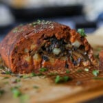 sliced sun dried tomato roast on a cutting board