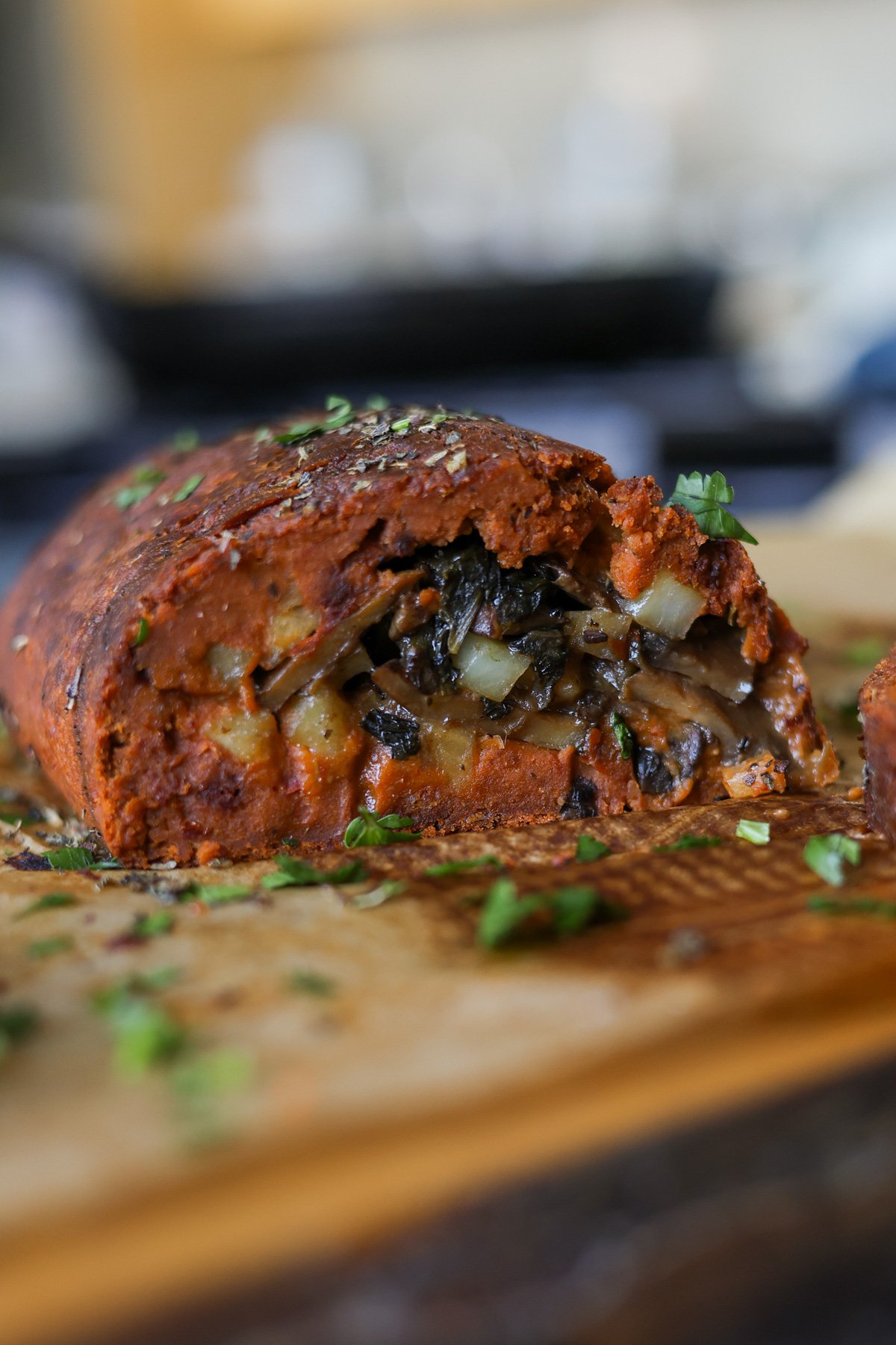 sliced sun dried tomato roast on a cutting board